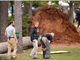 Course officials look over fallen trees on the 17th hole during the second round of the 2023 Masters Tournament at Augusta National Golf Club on April 07, 2023 in Augusta, Georgia.