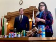 Carla Beck and Trent Wotherspoon stand at a table of groceries.